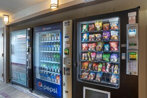 A row of vending machines with various snacks and drinks. - Best Western Crossroads Inn (De Funiak Springs)