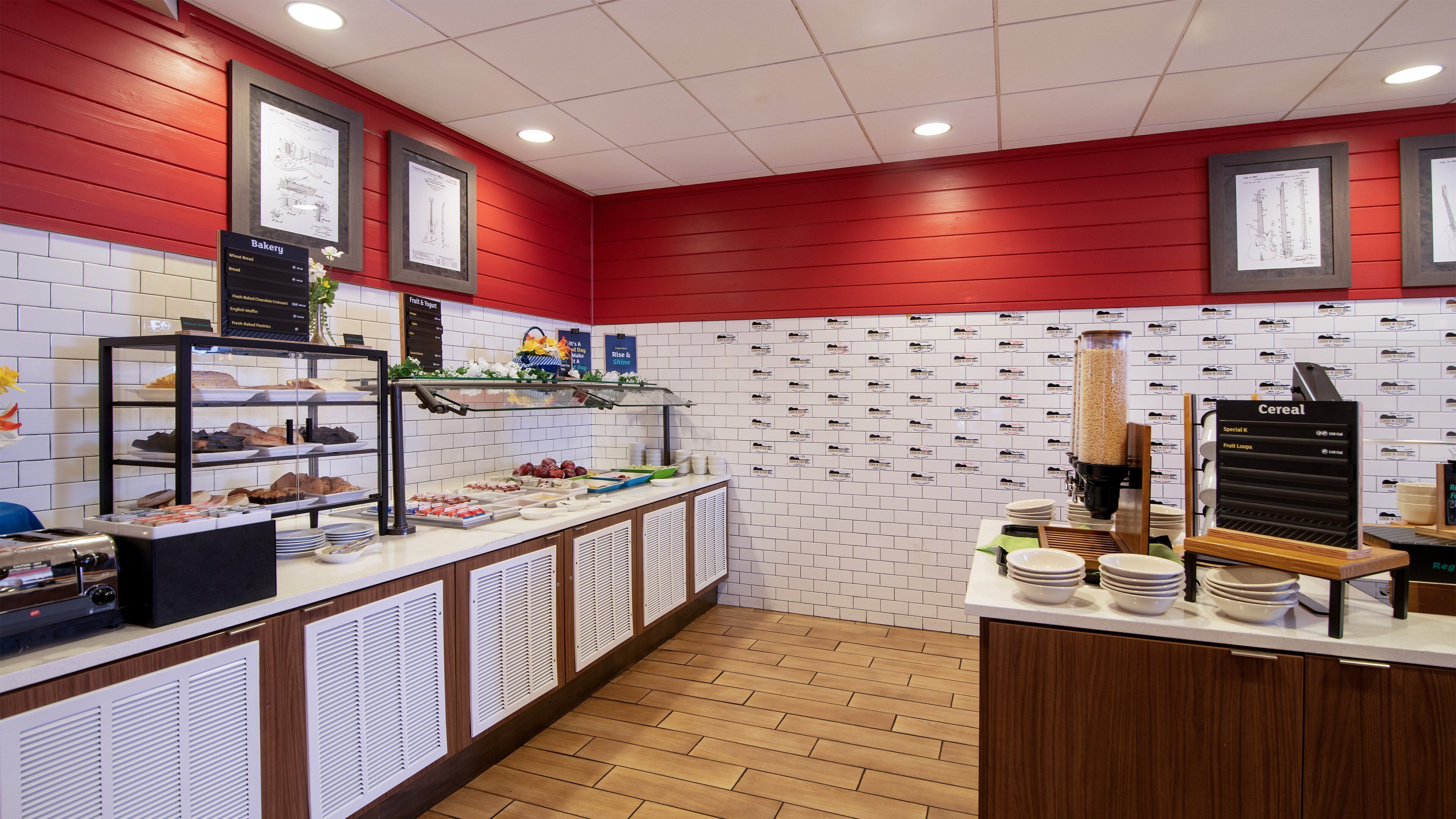 Un mostrador de panadería con diferentes productos horneados y un dispensador de cereales.