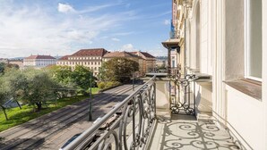 A balcony with a view of a cityscape, including buildings and a tram line. - Best Western Hotel Moran (Prague)