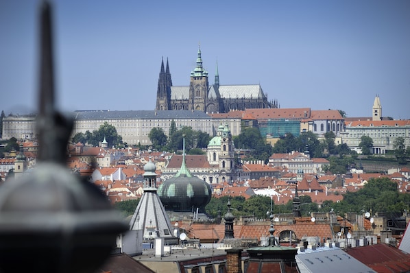 A cityscape with historic buildings, including a prominent cathedral with twin spires. - Best Western Hotel Moran (Prague)