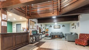 A lobby with a reception desk, seating area, and a coffee station. - Quality Inn Near Mammoth Mountain Ski Resort (Mammoth Lakes)
