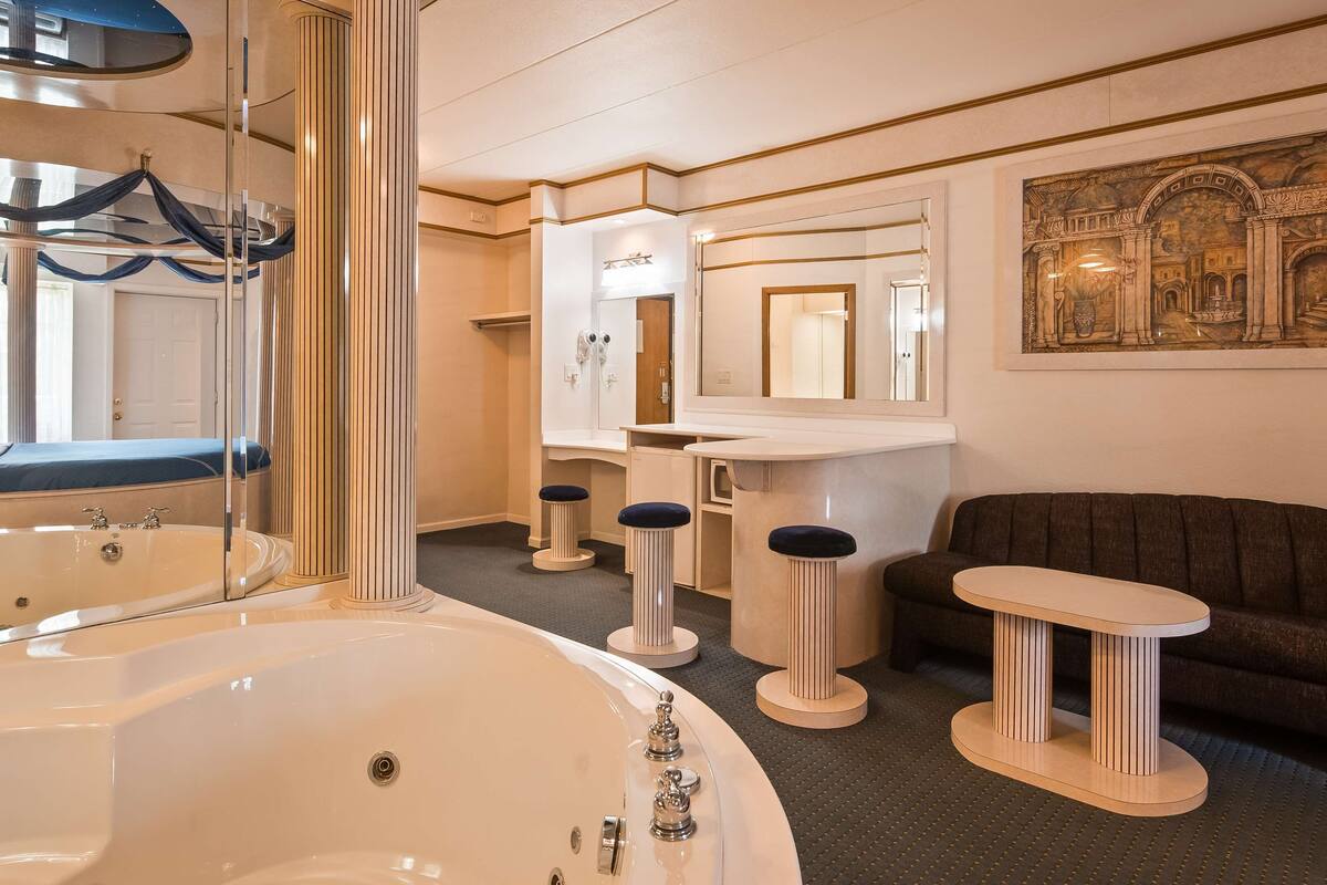 suite, 1 king bed, non smoking, jetted tub | blackout curtains, iron/ironing board, rollaway beds, free wifi