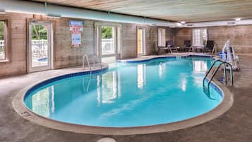 Una piscina cubierta, una piscina al aire libre, tumbonas