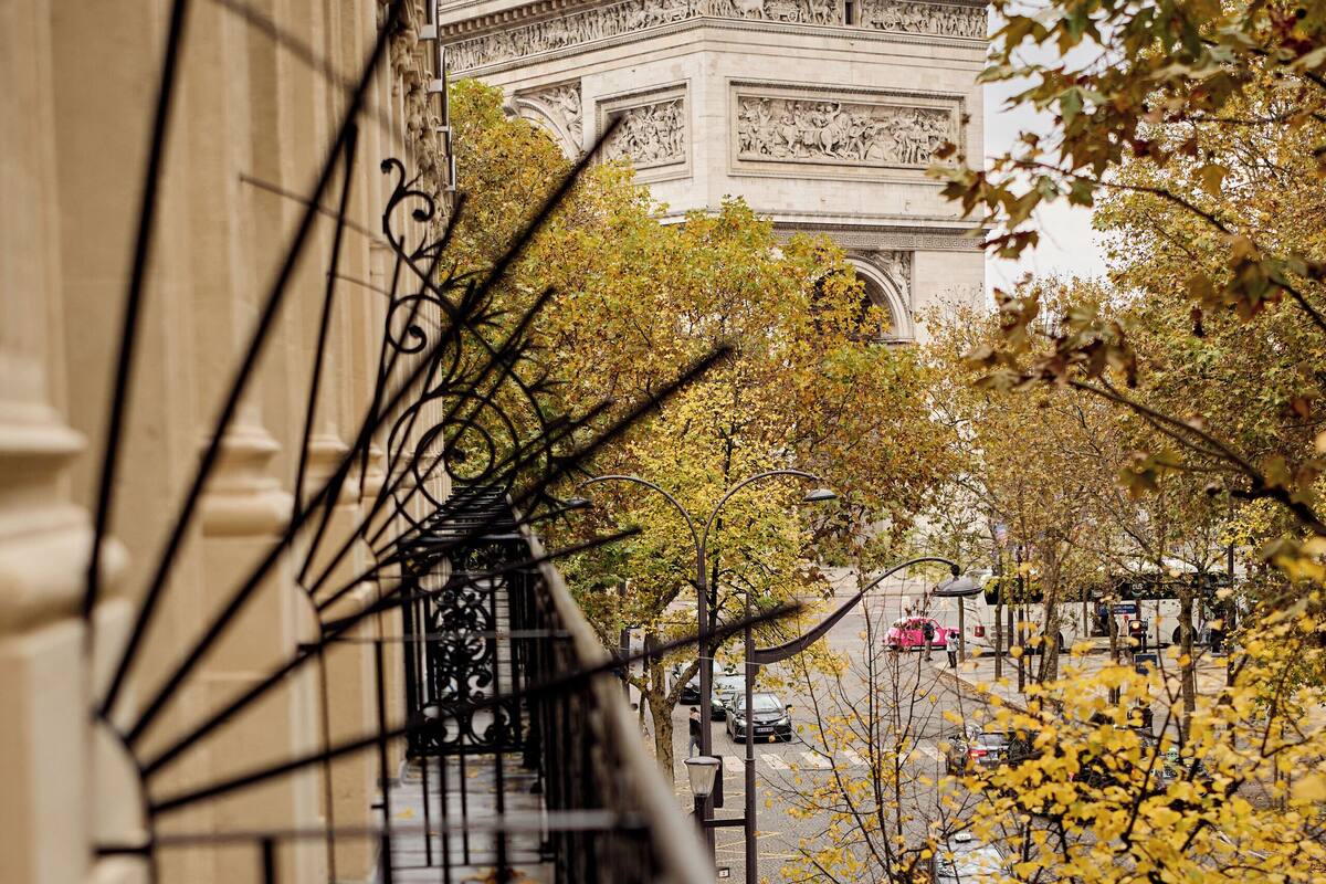 A view of a building with ornate iron railings and a street below.