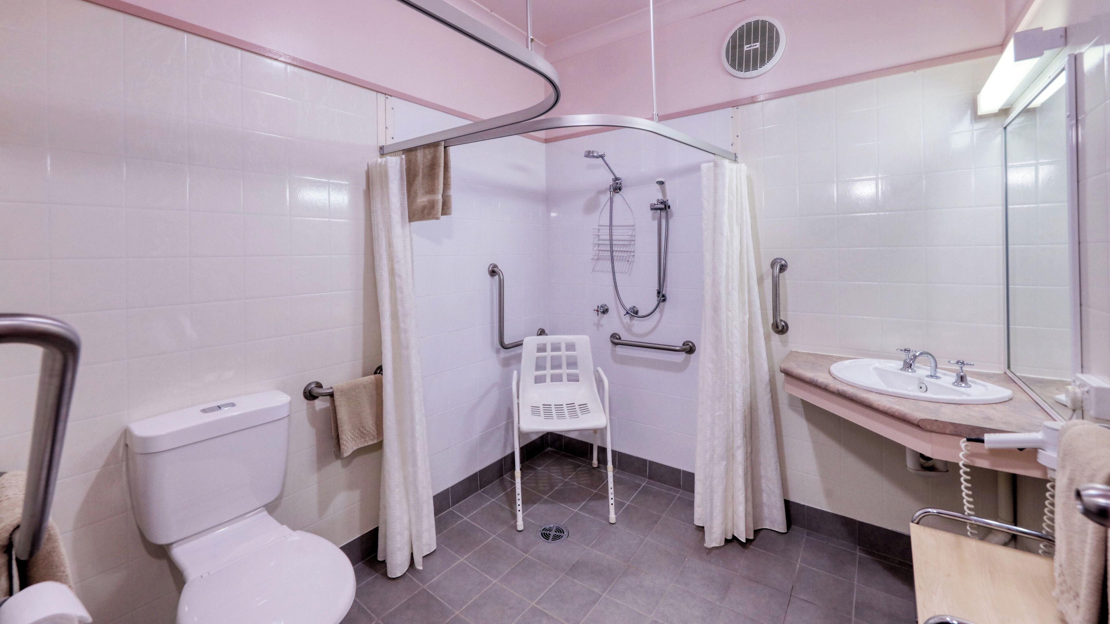 two-bedroom family suite with disability access | bathroom | shower, free toiletries, hair dryer, towels