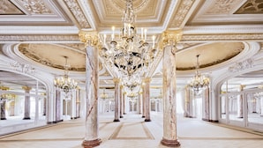 A grand hallway with ornate chandeliers, marble columns, and a symmetrical layout. - Carlton Cannes, a Regent Hotel (Cannes)
