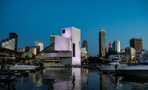 Stunning cityscape with a unique geometric building, sleek skyscrapers, and a marina.