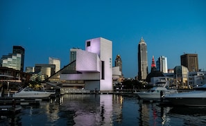 Stunning cityscape with a unique geometric building, sleek skyscrapers, and a marina.