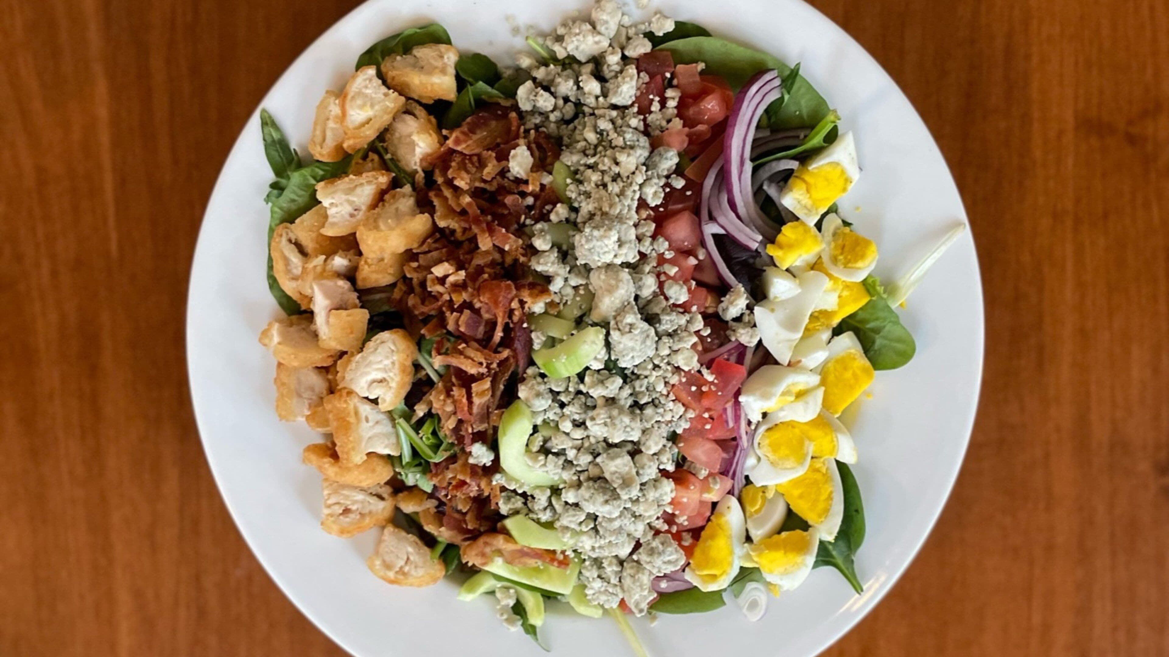 A plate of salad with various ingredients.