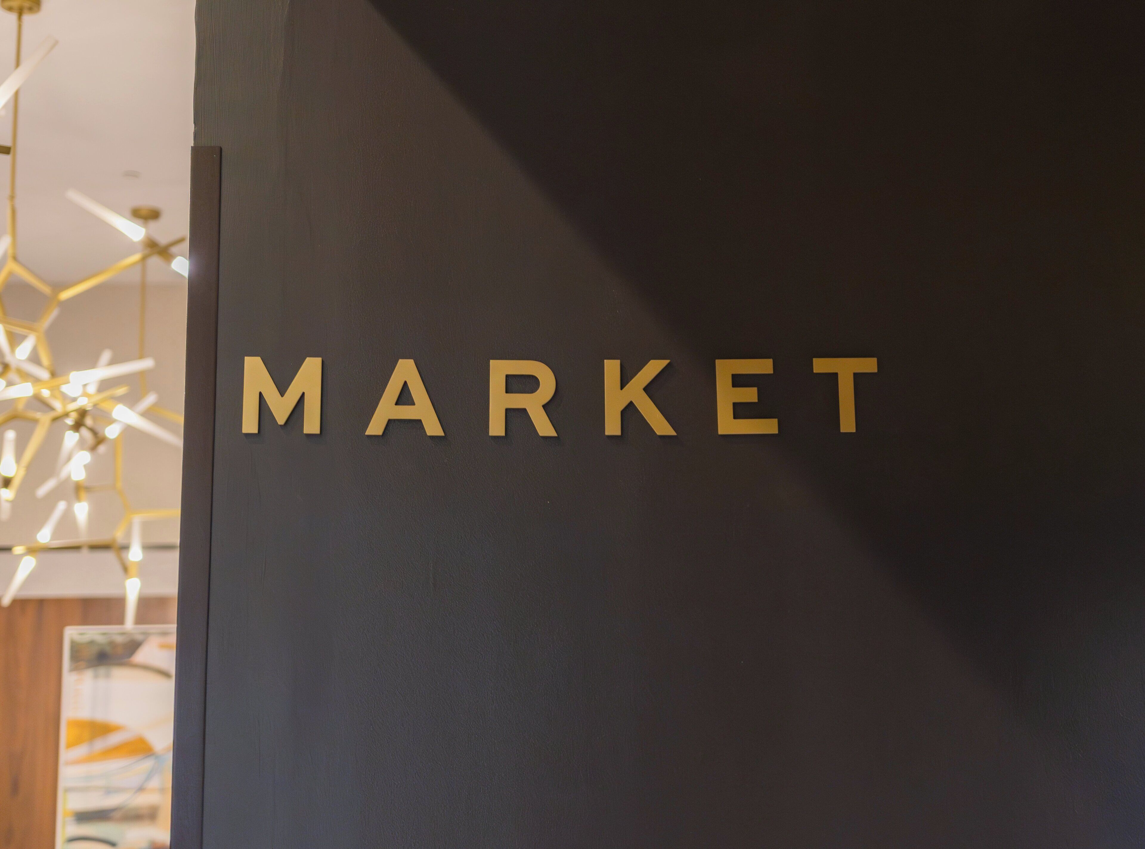 A dark wall with the word "MARKET" in gold letters.