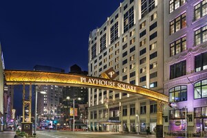 Playhouse Square with a prominent archway, a hotel entrance, and surrounding urban buildings.
