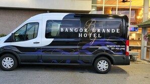 A van with "Bangor Grande Hotel" branding parked in front of the hotel. - Bangor Grande (Bangor)