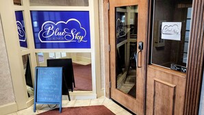 The entrance to Blue Sky Lounge with a sign indicating it is open daily from 11am to 10pm, offering Truly Raspberry and Lime Rickey drinks. - Bangor Grande (Bangor)
