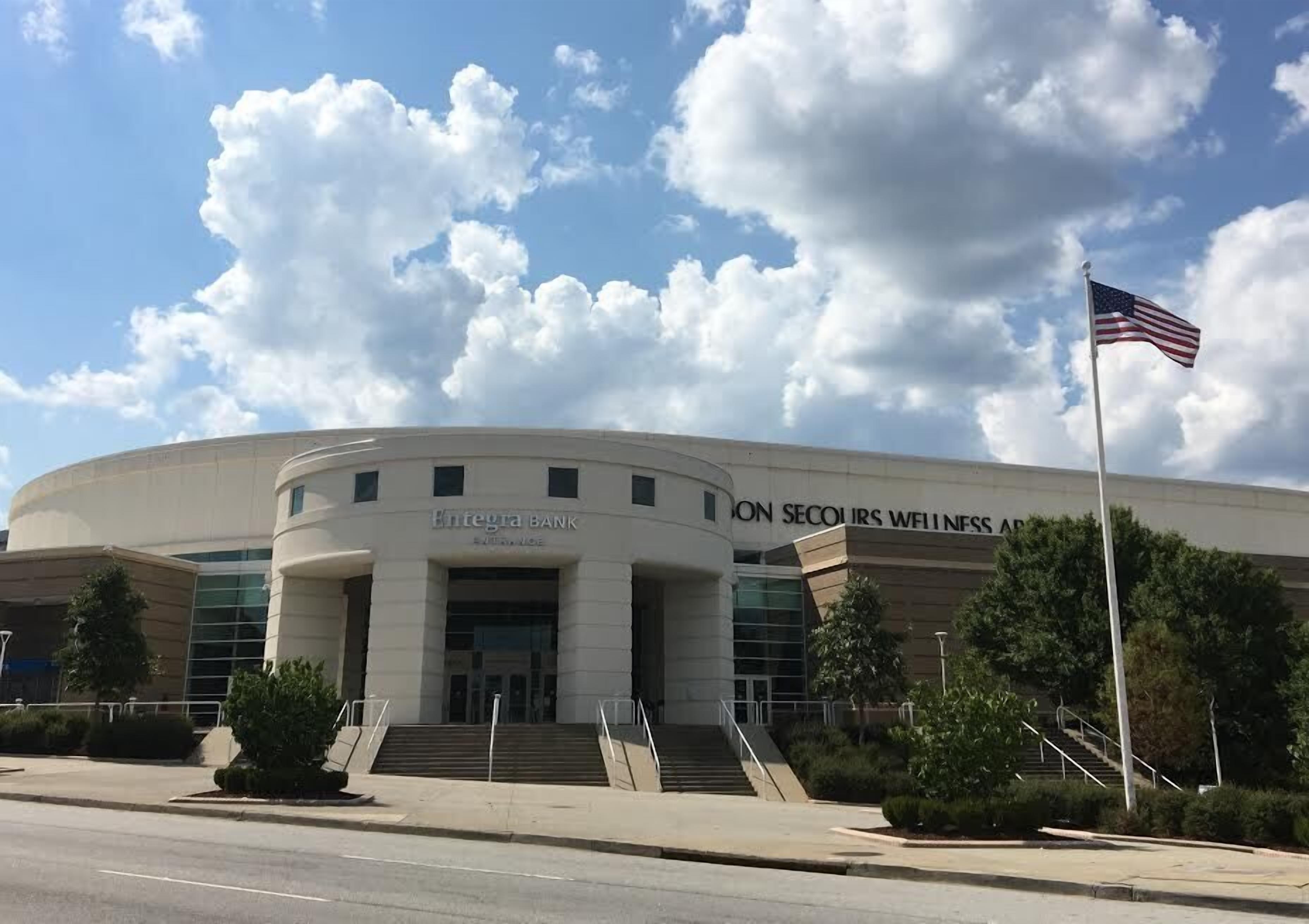 A bank building with a curved facade, steps leading up to the entrance, and an American flag on a flagpole.