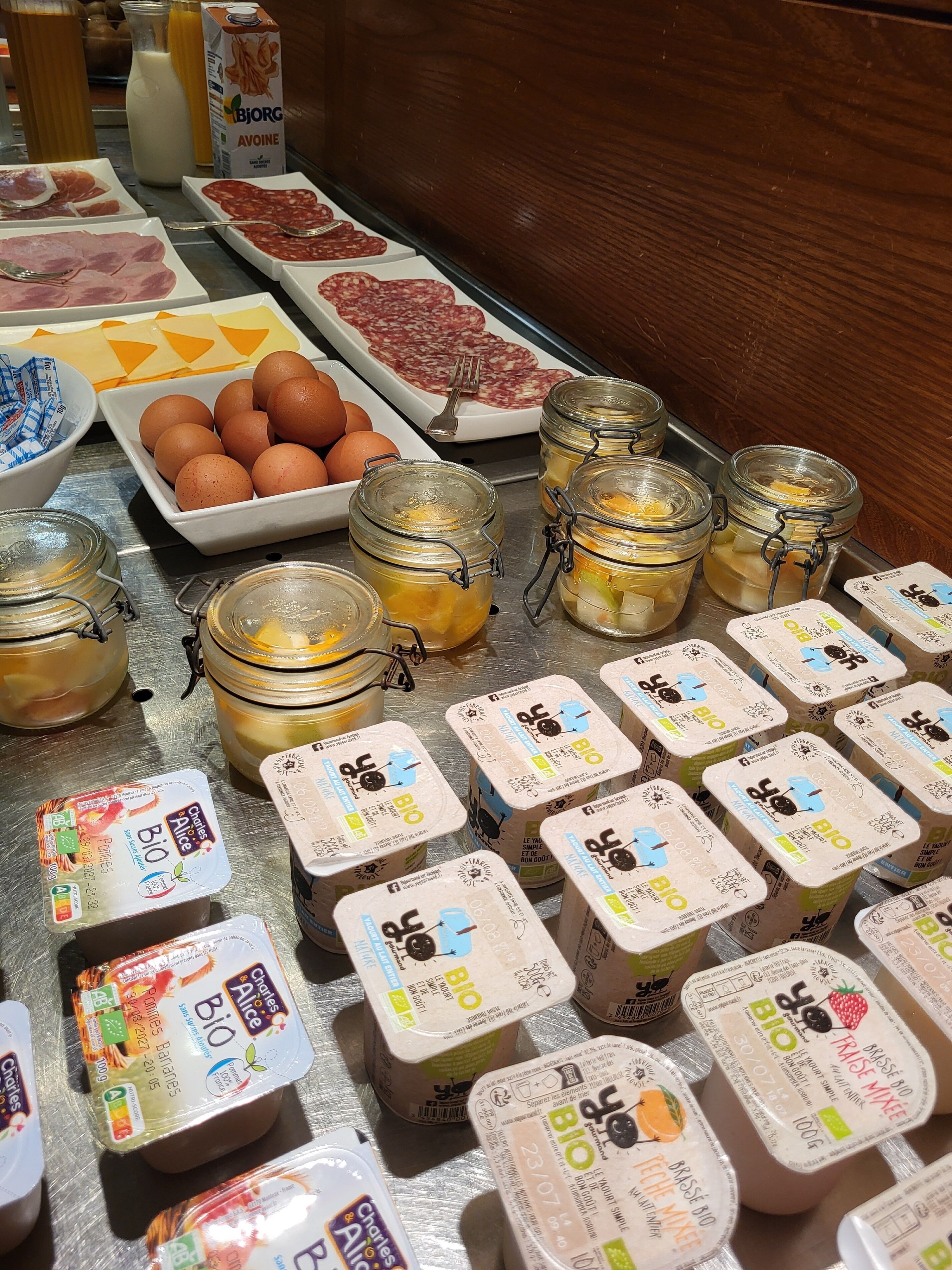 A breakfast buffet with various food items and containers.