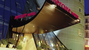 The exterior of the Mercure Hotel with a distinctive curved facade and a prominent entrance canopy. - Mercure Chambery Centre (Chambery)