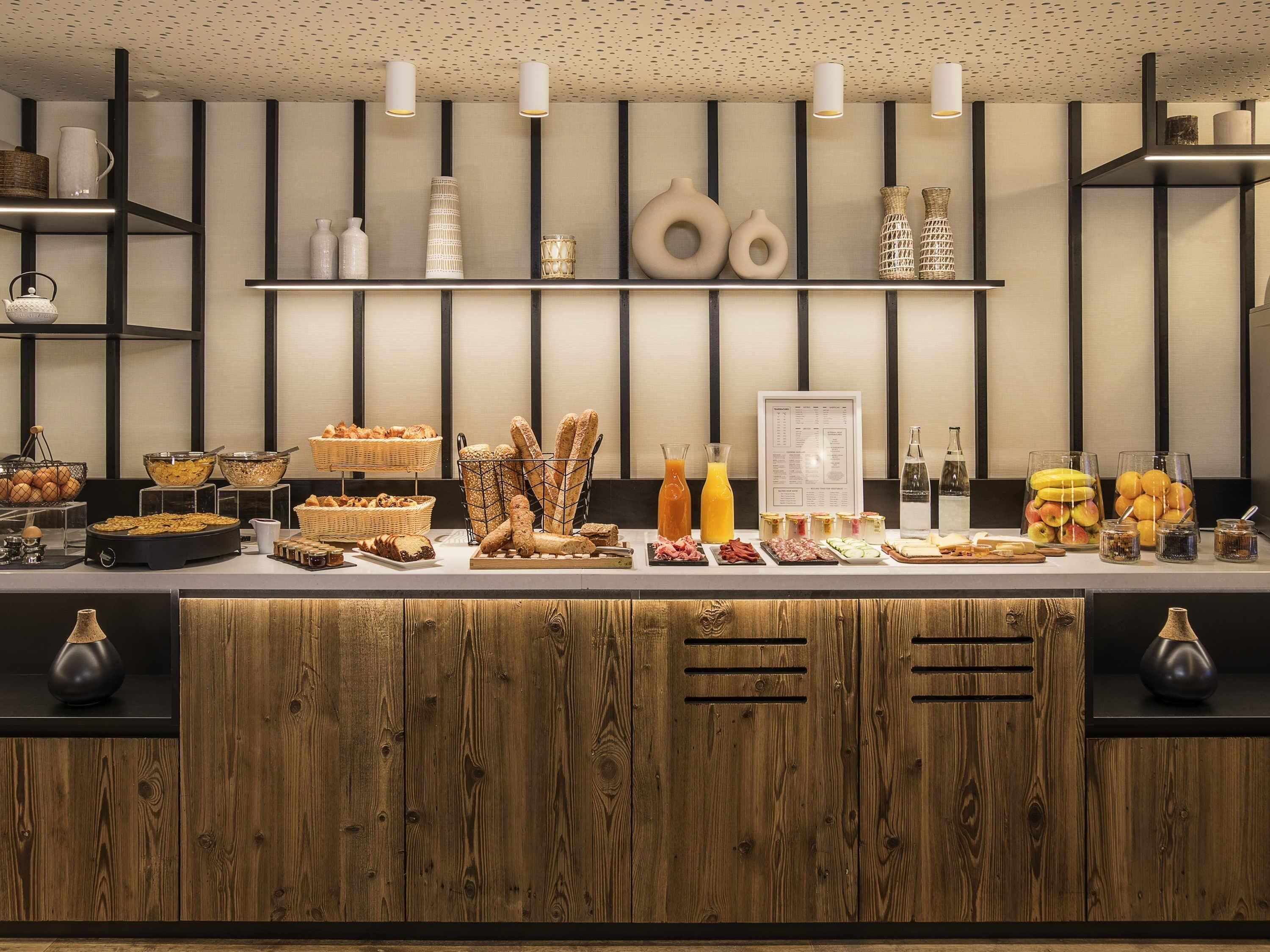 A buffet setup with various food items and beverages.