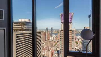 A high-rise building with a view of a cityscape through a window.
