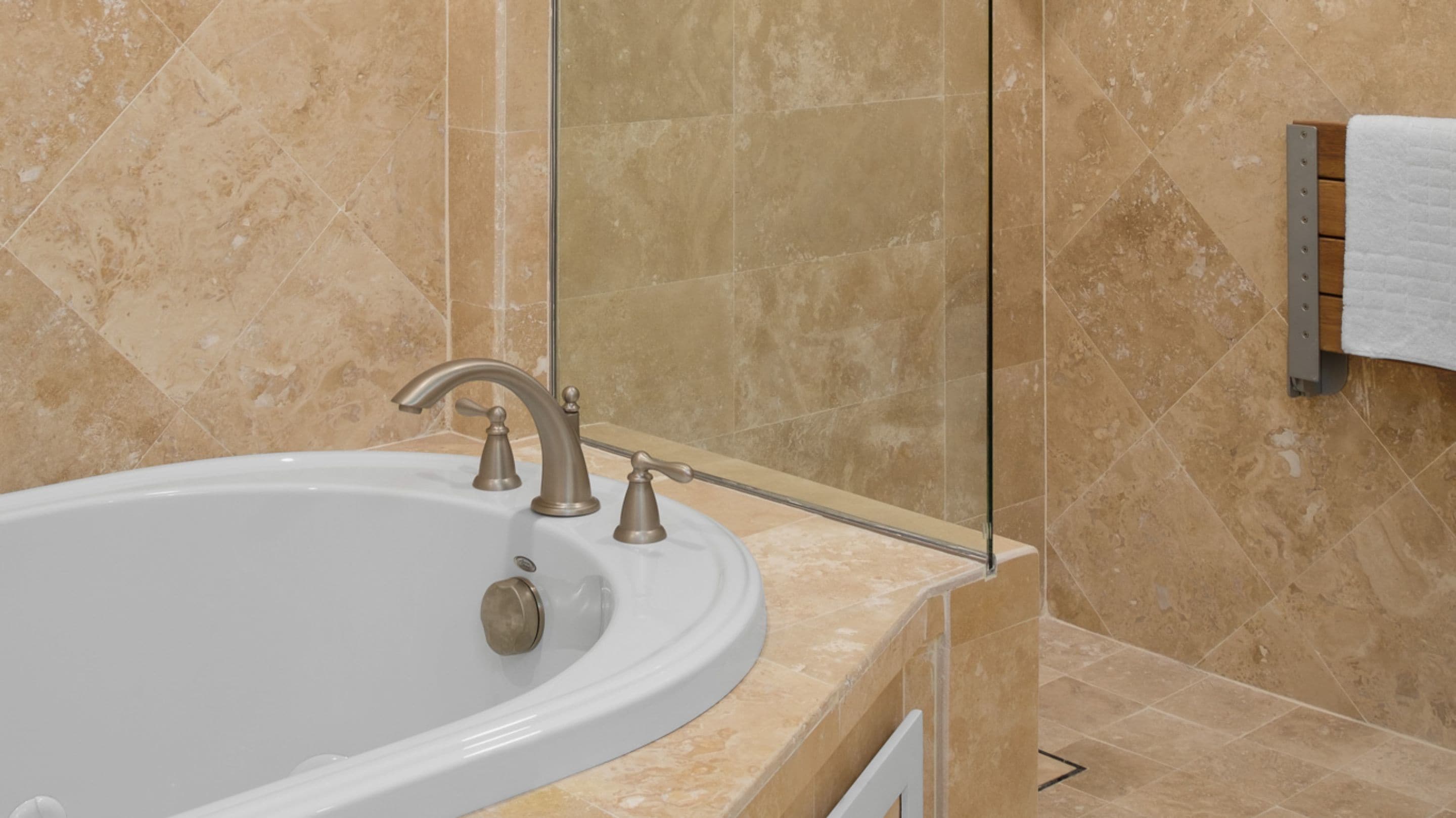A bathroom with a bathtub, a sink, and a towel rack.