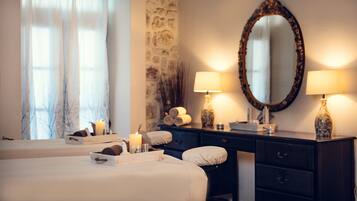 Relax in a spacious room with a large bed, dresser, and two lamps.