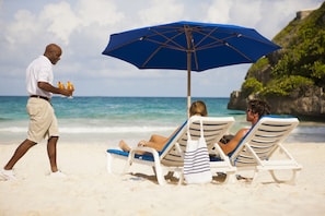 On the beach, white sand, beach towels, beach bar