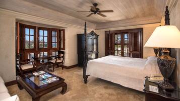 A bedroom with a bed, a desk, and a chair.