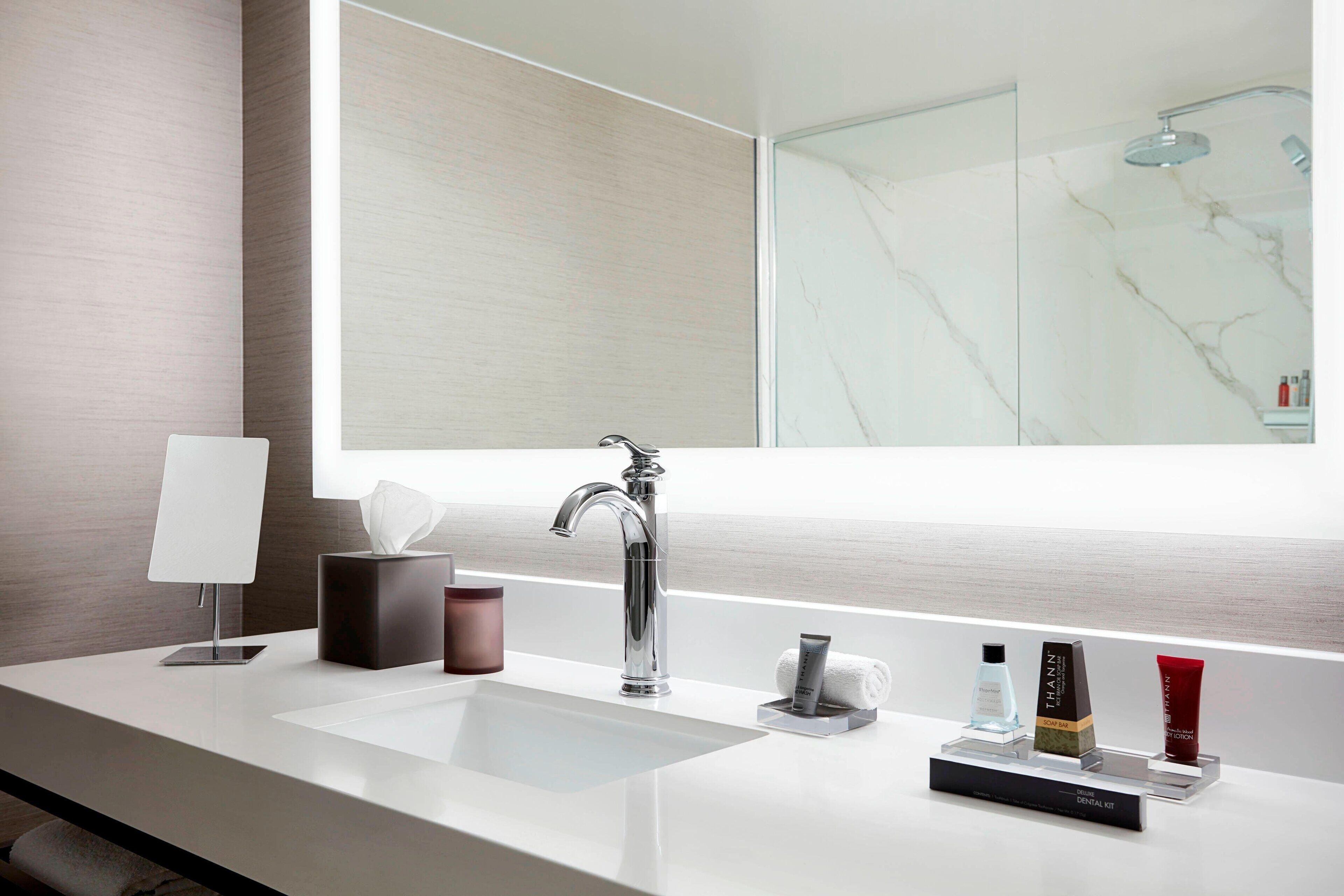 designer toiletries, hair dryer, towels