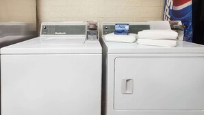 A Nuensch brand washing machine with a control panel and a digital display. - Days Inn by Wyndham El Reno (El Reno)