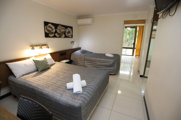 Suite empresarial, 2 habitaciones, cocineta, vista al jardín | Espacio para trabajar con laptop y cortinas blackout