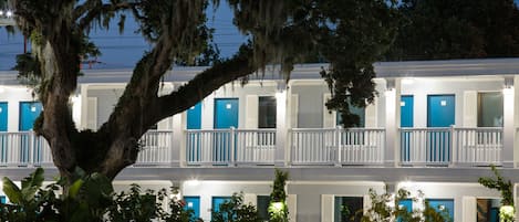 A two-story motel with blue doors and white railings.