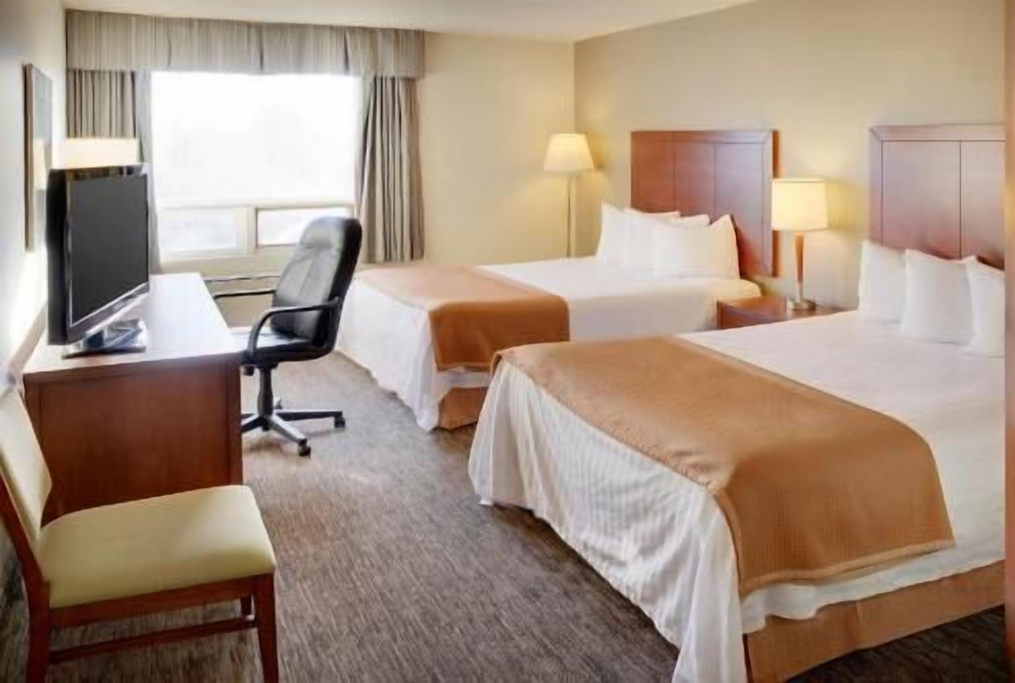 Pillowtop beds, desk, blackout drapes, iron/ironing board