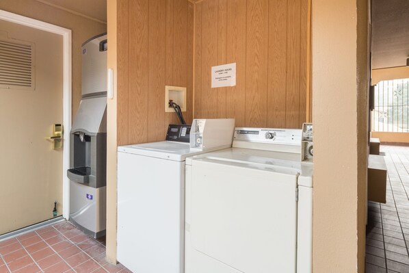 A laundry area with a washing machine, dryer, and a water dispenser.