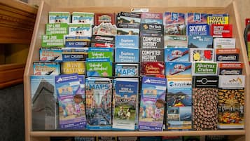 A wooden display case filled with various travel guides and maps.