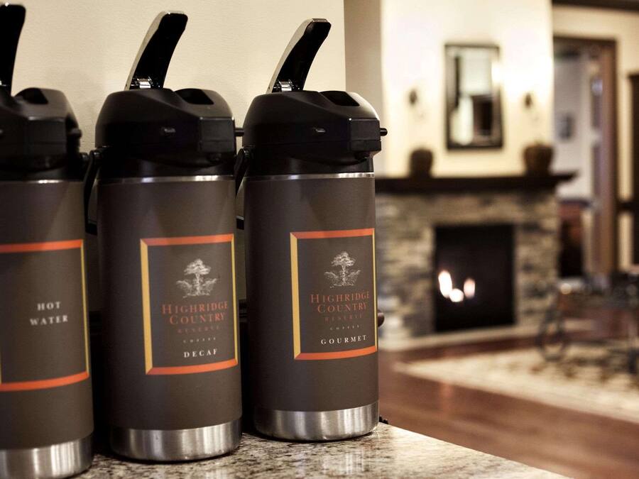 Three insulated water bottles labeled 'Highridge Country Reserve' on a kitchen counter.