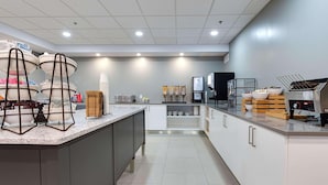 A modern kitchen with a central island, built-in appliances, and a clean layout. - Country Inn & Suites by Radisson, Niagara Falls, ON (Niagara Falls)