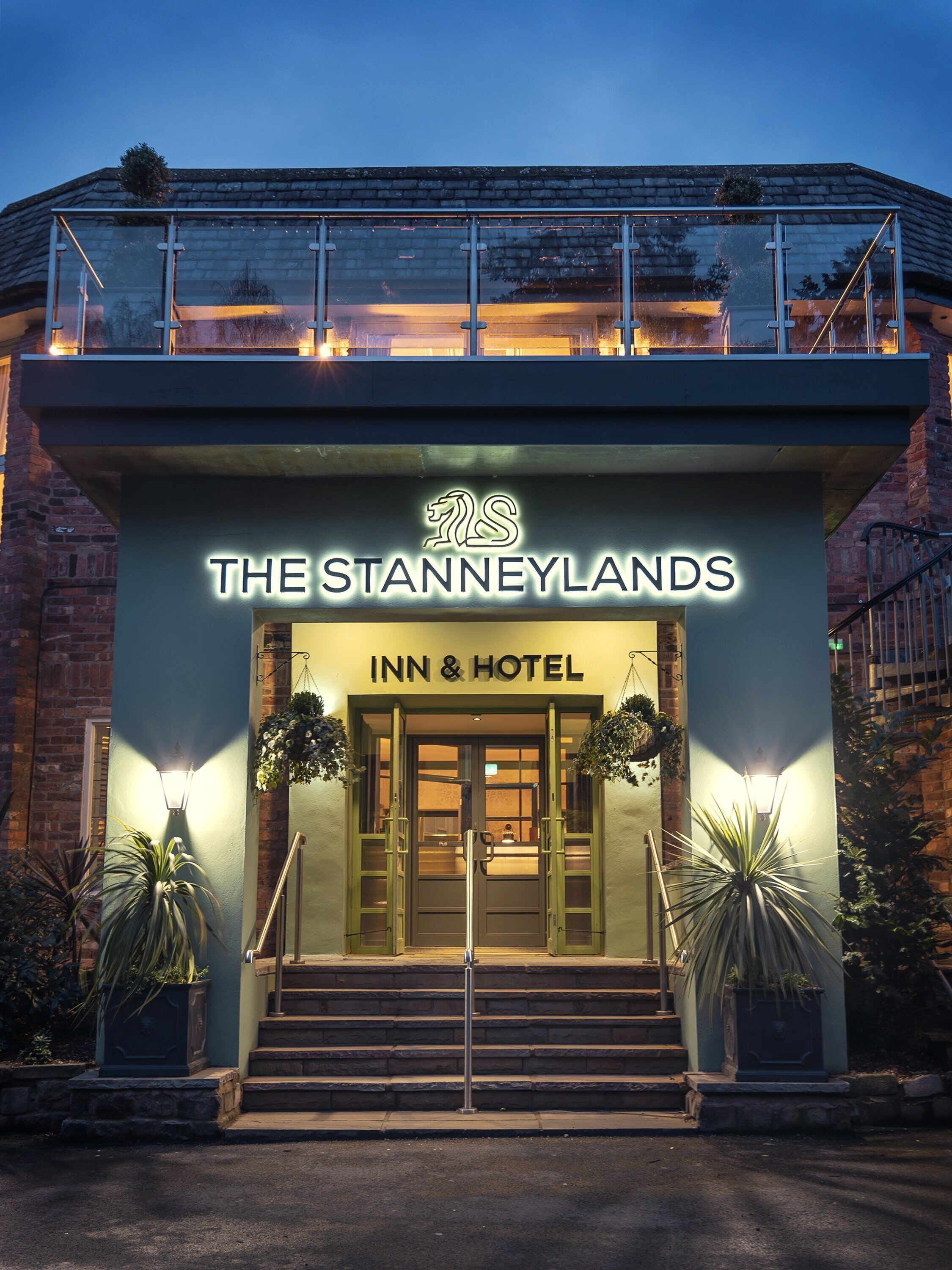 A hotel entrance with a sign reading "The Stanneylands Inn & Hotel".