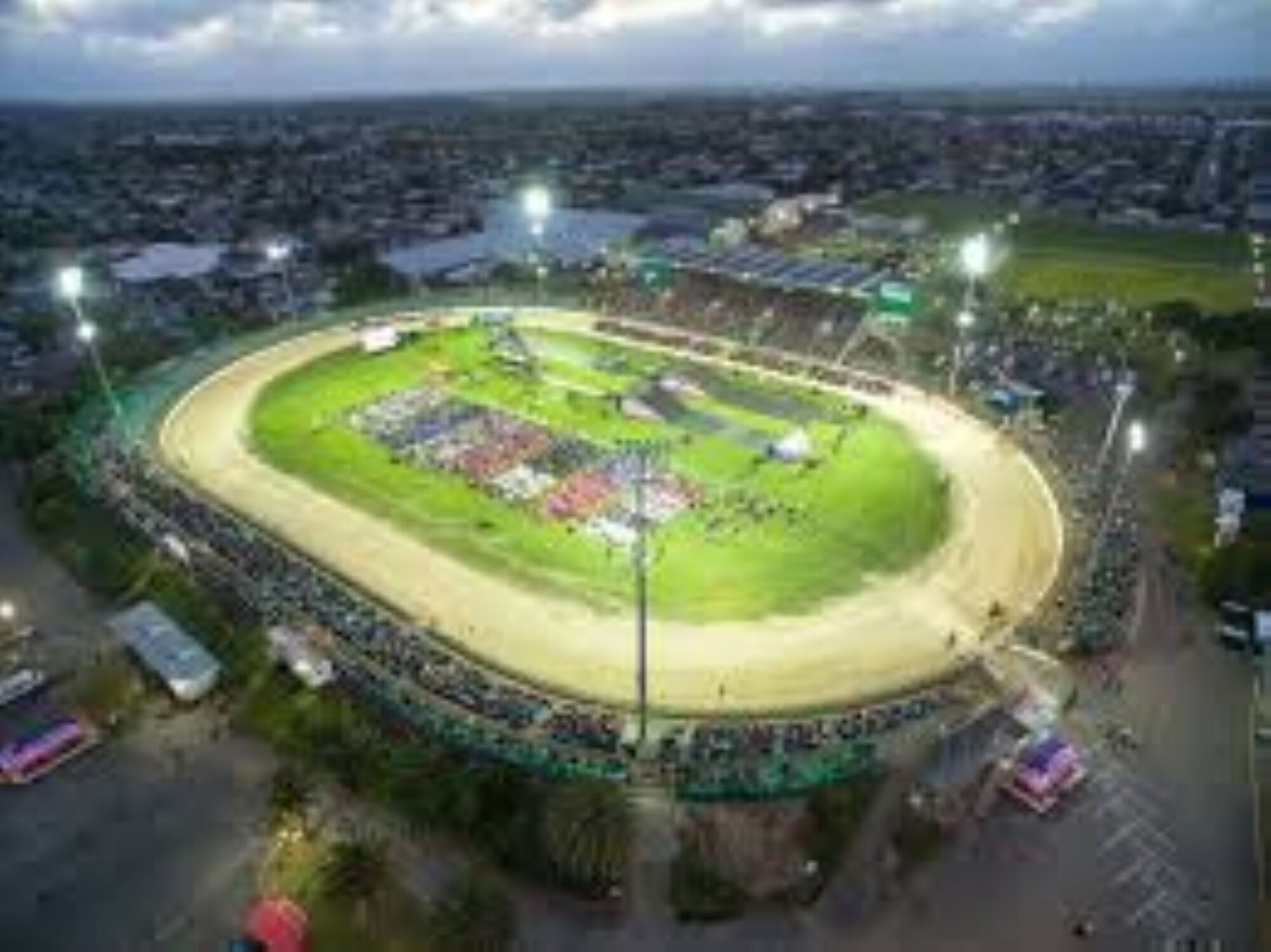 A large stadium with a track and seating area, surrounded by a cityscape.