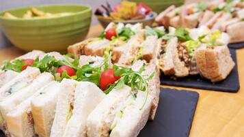 A variety of sandwiches and salads on a table.
