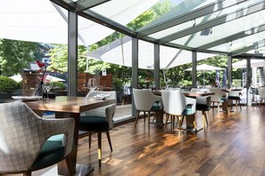 Enjoy a casual dining experience amidst lush greenery with a view.