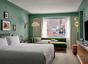 Deluxe Room, 1 King Bed | Hypo-allergenic bedding, in-room safe, laptop workspace, blackout drapes at Romer Hells Kitchen