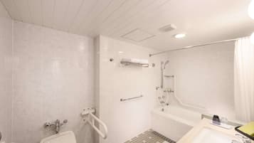 A modern bathroom with a shower, toilet, and sink.