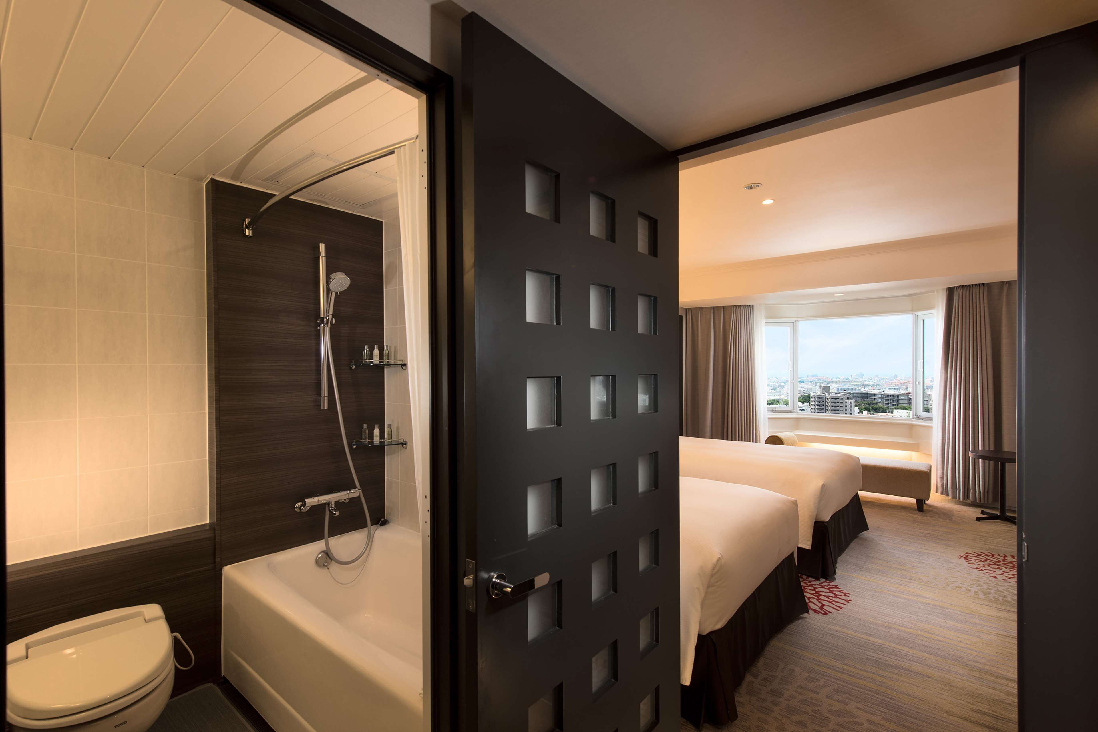 twin deluxe suite | bathroom | combined shower/bathtub, free toiletries, hair dryer, slippers