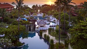 A resort with a swimming pool, palm trees, and a waterfall. - The Westin Resort Nusa Dua, Bali (Nusa Dua)