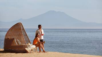 Beach nearby, white sand, beach umbrellas, beach towels