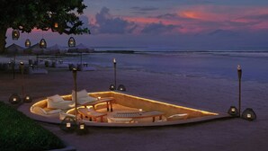 A beachside lounge with outdoor seating, a fire feature, and lanterns. - The Westin Resort Nusa Dua, Bali (Nusa Dua)