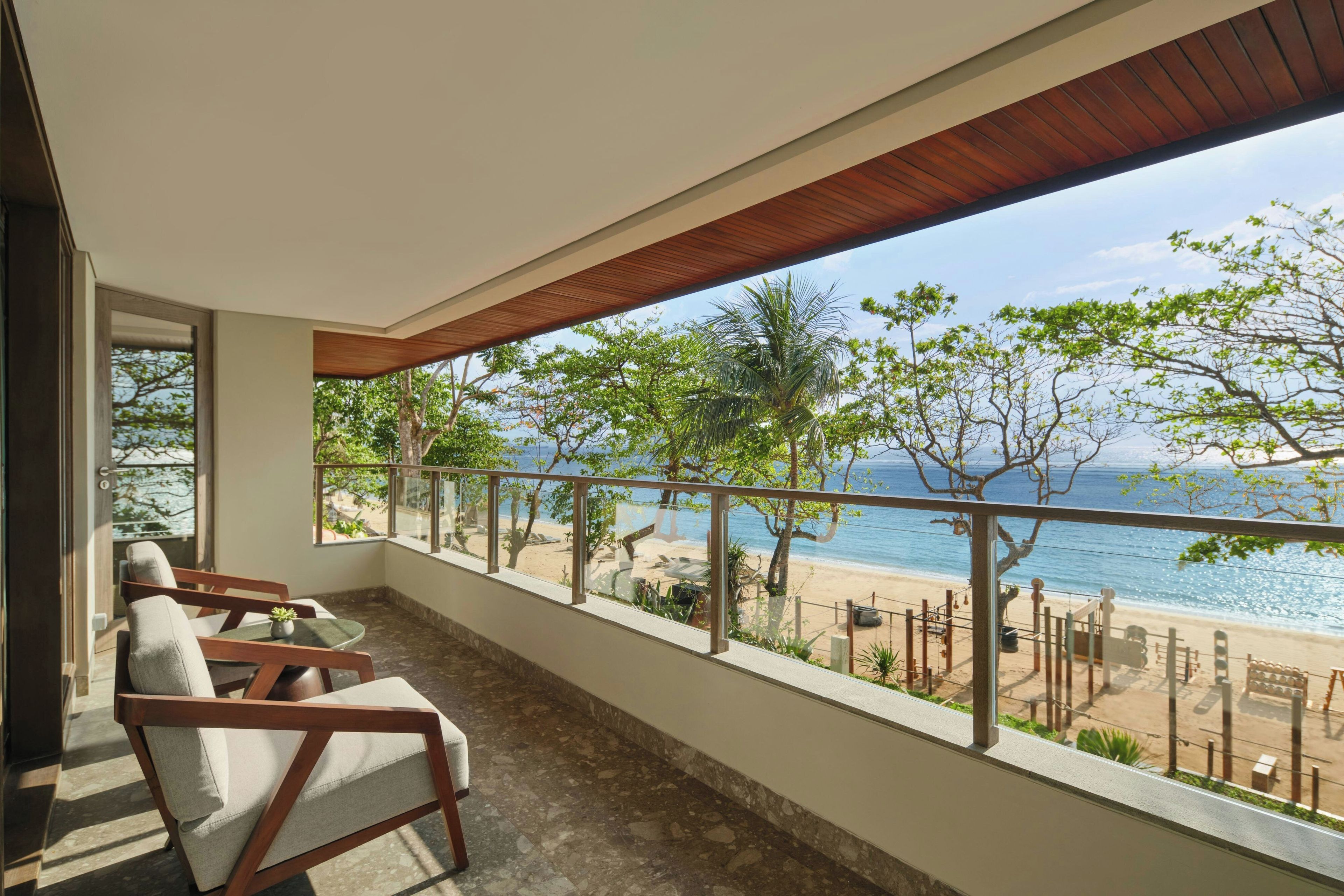 A balcony with a view of a beach and ocean.