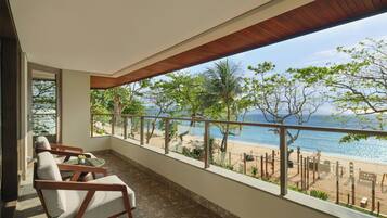 A balcony with a view of a beach and ocean.