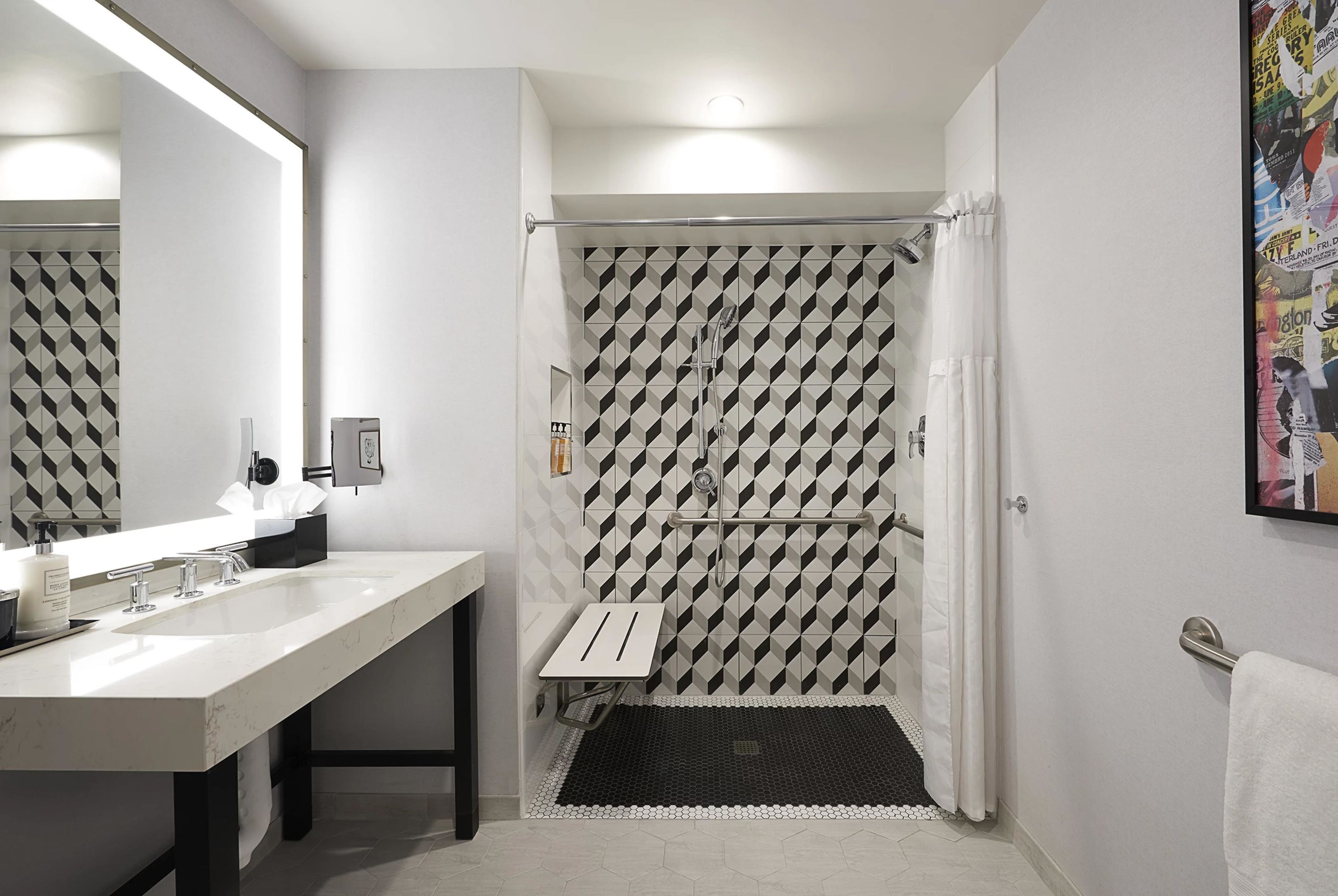 A modern bathroom with a white sink, mirror, and shower.