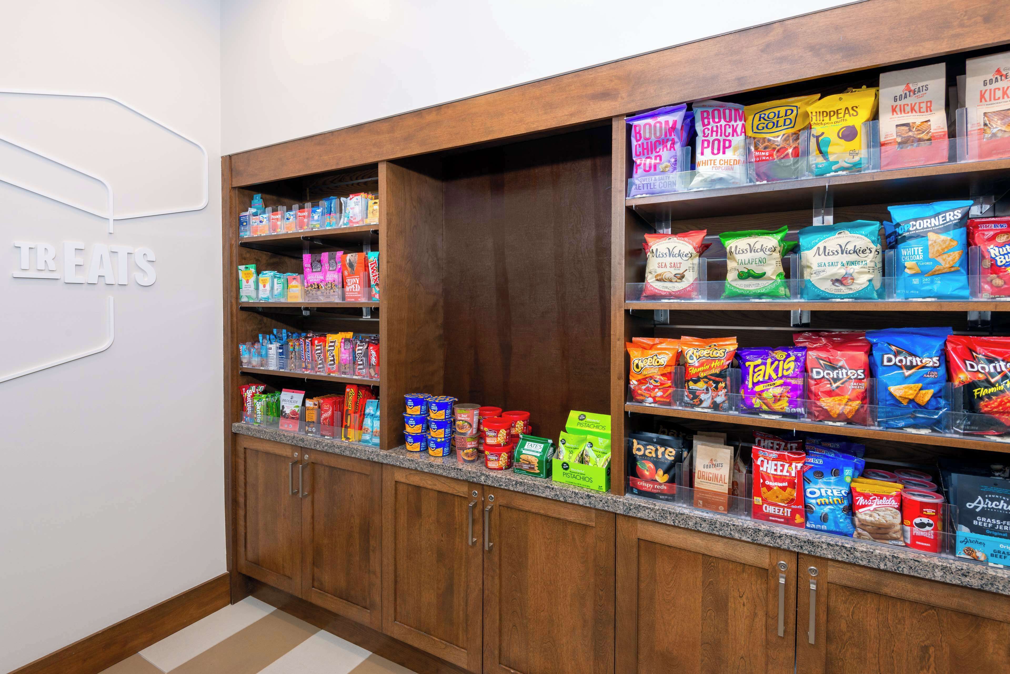 A snack display with various brands and types of chips and snacks.