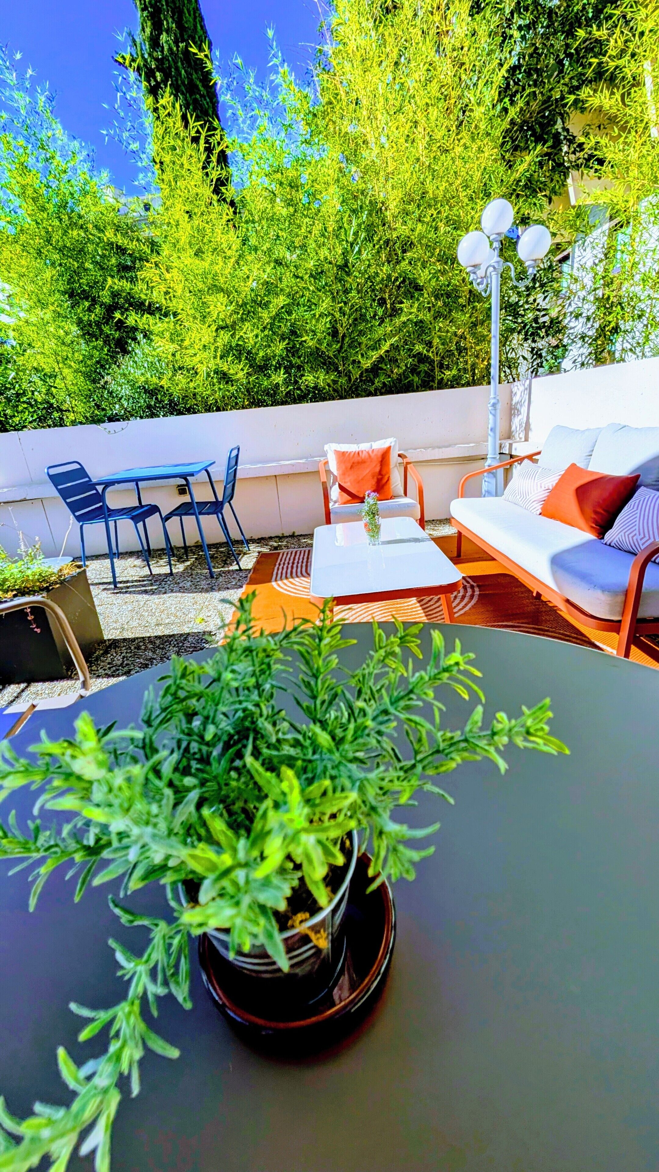 An outdoor seating area with a table, chairs, and a sofa.